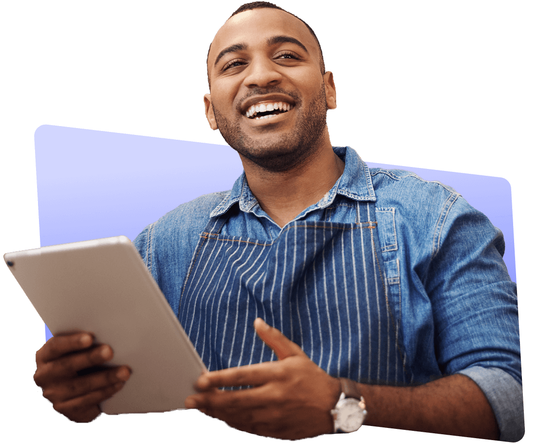 Smiling male employee holding a tablet